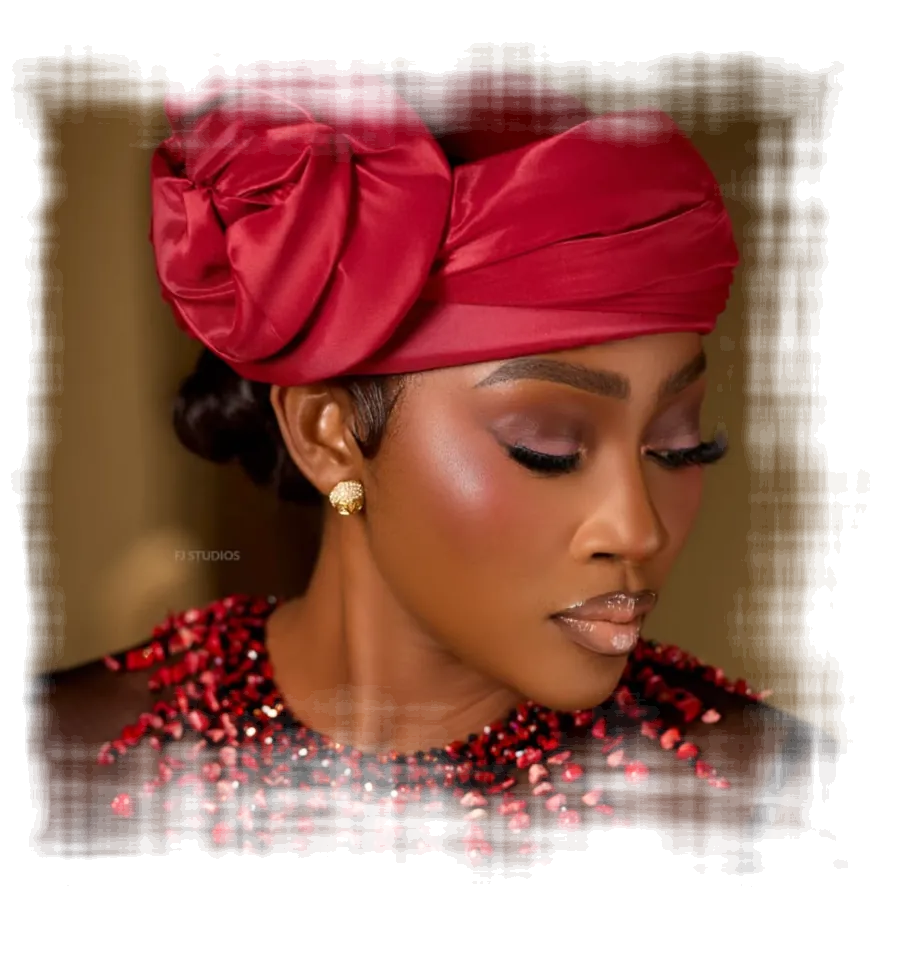 Woman wearing a red satin turban with a coral bead neckpiece